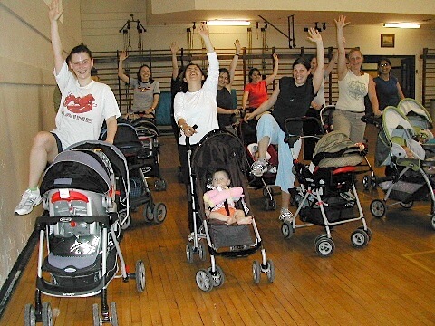 Class of new moms exercising with their babies in strollers.