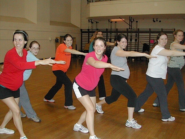 Pregnant women exercising in a gym.