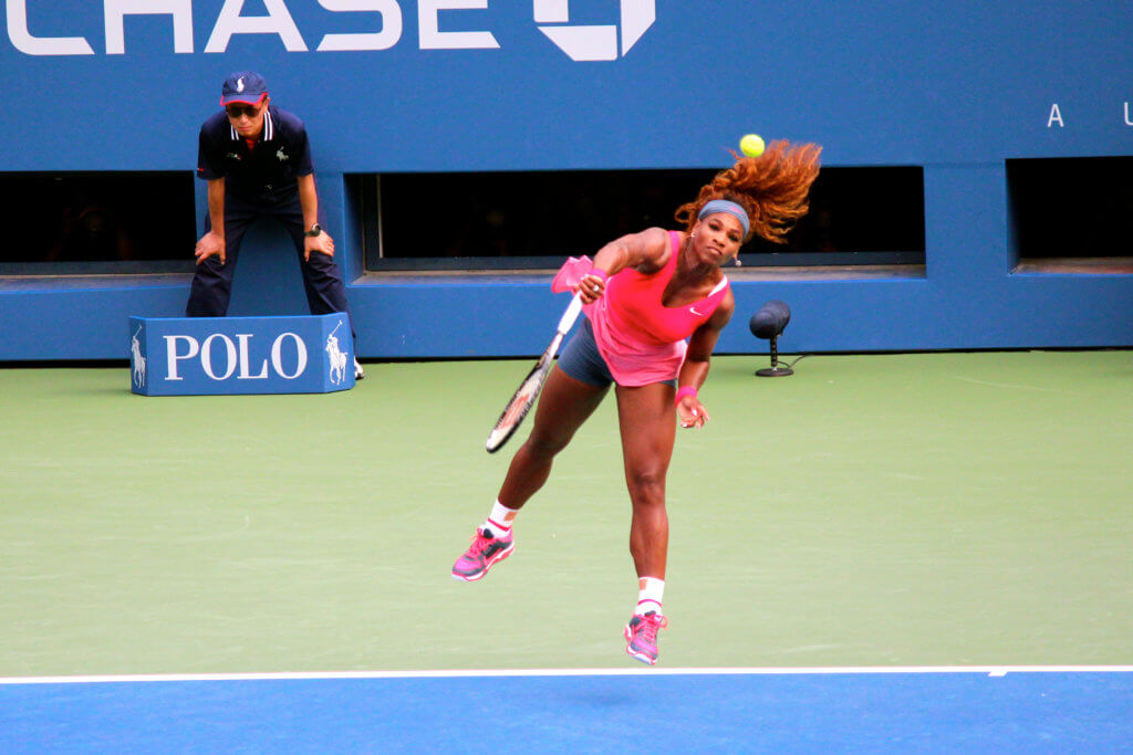 Serena Williams, tennis player, serving at the U.S. Open.