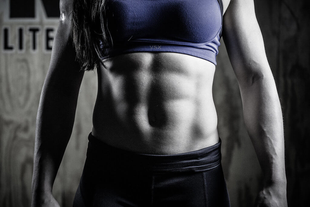 Image of a woman's abdomen, showing off toned abdominal muscles.
